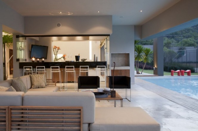 The pool deck is a play on outdoor-indoor. The den or deck area is easily accessible to the infinity pool area.