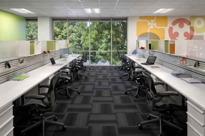 These desks are bench-like and shared, but for those engaged in sensitive work such as human resources,  more private semi-enclosed offices were designed, using white noise technology to maintain acoustic privacy.