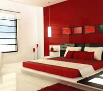 Design by Zaib. This ultra modern red bedroom, is accessorized with light panels, unique red vases, and hanging vertical lights. The intensity of the red and brown colors are relieved by the cream colored pillows and floors.