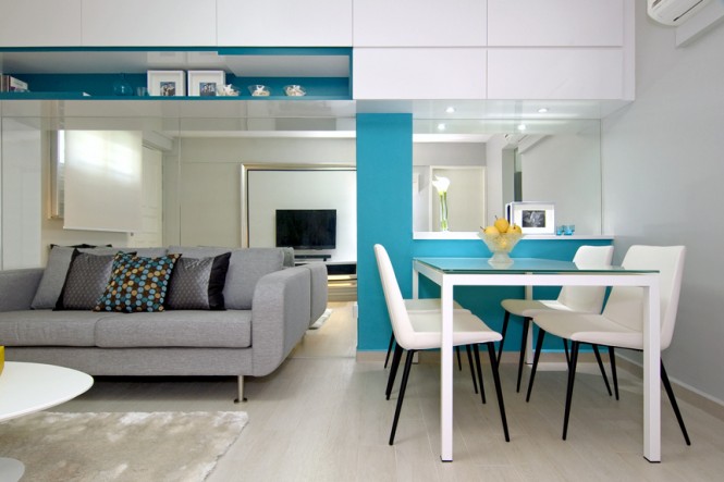 An aqua blue and yellow color play was devised to prevent the apartment from appearing too feminine, and bring a cool freshness to the once dowdy setting. Stylish accessories and unusual fabrics were layered in to add life and fun to the space.