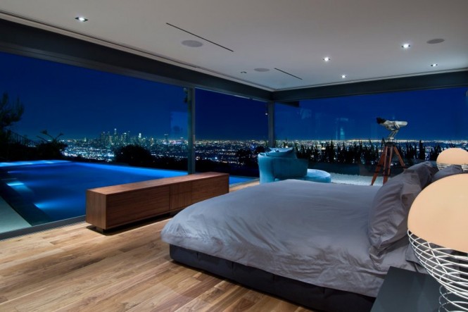 Image by MaccollumA sprawling cityscape view adds to the magic of a bedside swimming pool on this roof space, nested high above the bustling city lights.