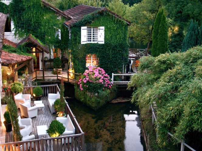 Le Moulin Du Roc Hotel in France is simply a living fairytale, adorned in rich greenery that cascades like an emerald waterfall around peeping window shutters and romantic balconies, just blissful!