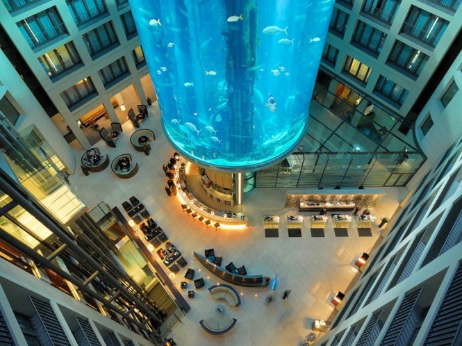 Nestled beneath a colossal, cylindrical aquarium that reaches up several stories high, the central core of the Radisson Blu Hotel in Berlin is a spectacle to behold.