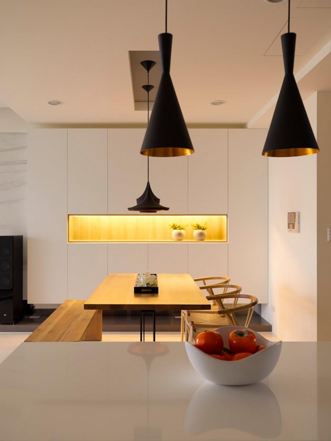 Zone pit stops can be created with the introduction of carefully placed pendant lights in strong colors; this interior uses bold black shades in varying shapes to draw the eye and define each area.