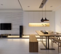 A letterbox of light flanks the dining place, creating ambient lighting as well as breaking a plain wall.