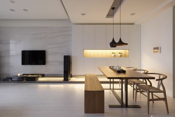 A letterbox of light flanks the dining place, creating ambient lighting as well as breaking a plain wall.