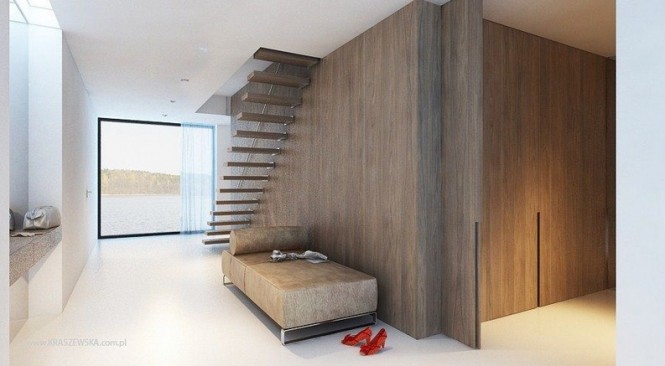 A floating staircase allows light and views to flow unobstructed through a narrow hallway space.