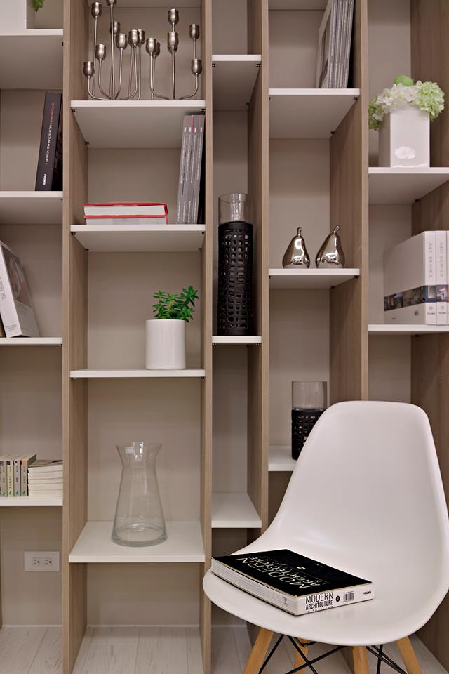 A home office situated behind the lounge is backed by a huge wall of attractive shelving that is divided into irregular cubby holes, where attractive items can be displayed over undulating levels.
