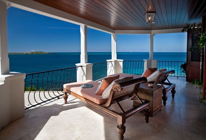 Another outdoor lounging area is situated on the upper floor of the two level property to offer further appreciation of the sea vistas from cushioned chaise lounges–the perfect place for sipping cocktails as yachts sail by on the horizon.