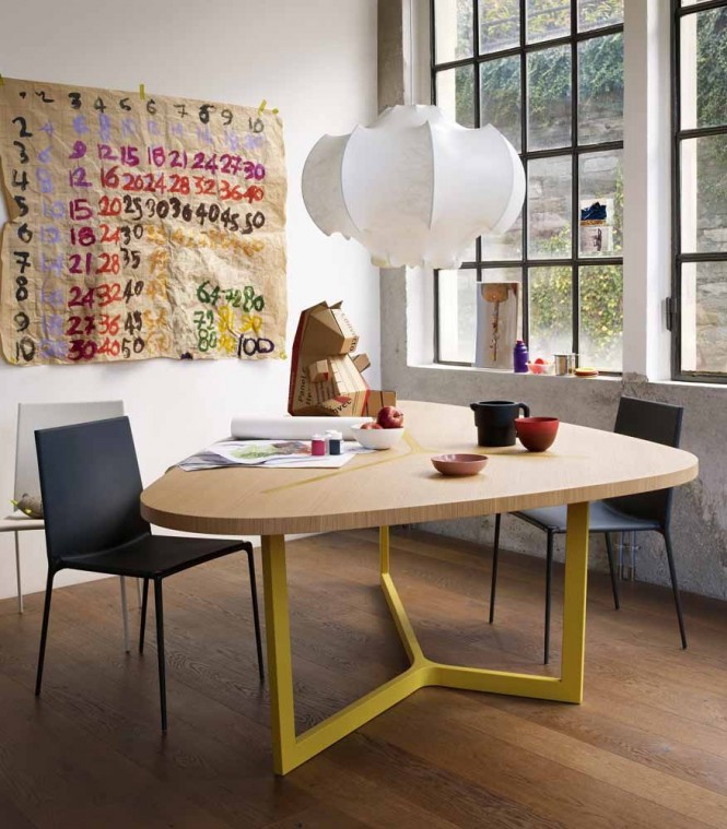 This contemporary table, complete with acid yellow legs gives an edgy look to the corner of the room with its irregular shape.