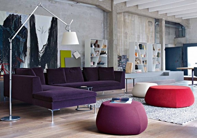 The red and purple passion spills out into the lounge area by way of an oversized L-shaped grape sofa and funky footstools.