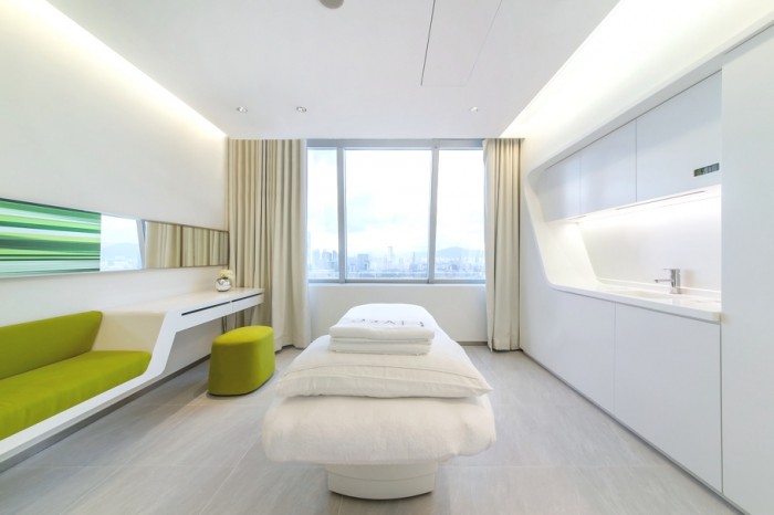 The treatment rooms within the skin care center are designed with multifunction in mind, to allow them to work on an aesthetic level as well as a practical one; a sliding picture conceals a mirror over a cosmetic table, which also forms an attractive way in which to prevent reflection inside the room during laser treatment.