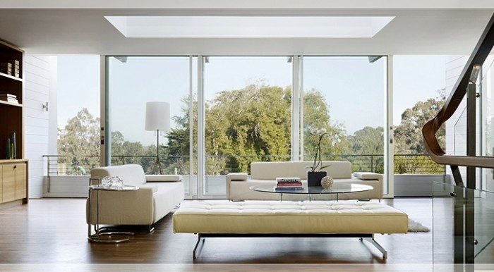 Architect John Maniscalo created this contemporary house around the ultimate use of natural light. With its retracting wall of windows and large open skylight, this living area looks as if it is floating in the trees.