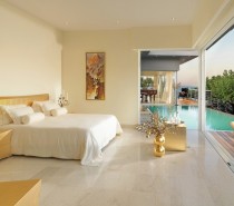 A retracting wall opens the master bedroom to the vast water views beyond and another of the villa's pools.