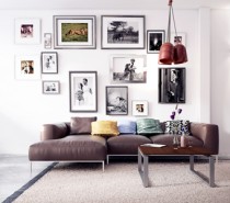 A gallery art wall adds height above a low-profile sofa taking the eye upward toward the soaring ceiling.