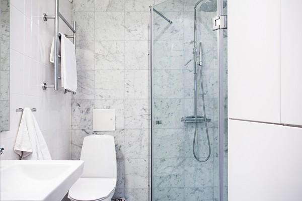 This crisp bathroom scheme is tiled in Carrara marble over heated floors.