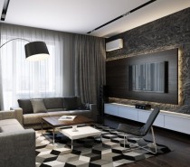 This sophisticated black and gray design uses pattern and texture to bring all of the interest. A large geometric patterned area rug demands attention in the living area, along with a heavily textured feature wall that is highlighted by an illuminated TV surround.