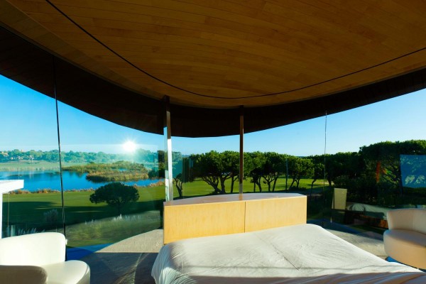 A green panorama and blue skyscape replaces the usual need for wall paper in this unusual master bedroom suite; who could have the morning blues when waking up to a footboard view like this? To feel truly like the king of this castle, this room is cantilevered over the private pool, and even has its own jacuzzi terrace.
