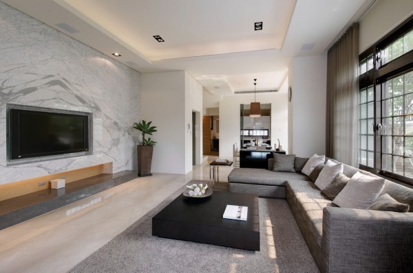The first living room we come to is decorated in subtle shades of gray, a gentle yet modern neutral that would be a sympathetic décor choice for a home built in any period. This particular example is a contemporary scheme with crisp L shaped sofa design, low-line coffee table and an entertainment wall that offers a recess for a flatscreen television.