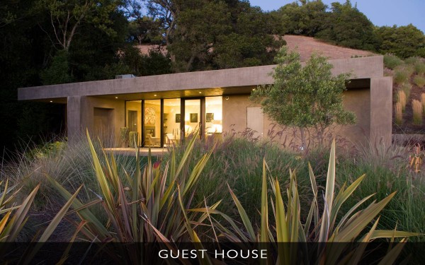 A separate guesthouse gets a matching contemporary treatment, complete with large glazed doors and an expanse of windows that look out onto the surrounding bay and oak trees. The detached block is home to one bedroom, a bathroom, and it's very own living room complete with fireplace, and a kitchen that doesn't skimp on more gourmet appliances.