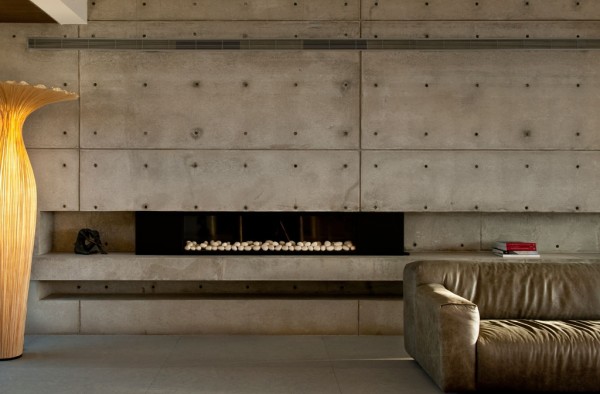 A fireplace built directly into a concrete wall is not only a feat of engineering, but makes a beautiful sight even when the fire is out.