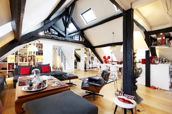 This attic apartment makes use of every opportunity to create and play with its black and red theme. From throw pillows to cheeky art and an enviable Eames chair, the apartment matches itself without feeling overly done.