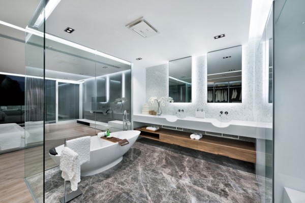 Enclosing an en suite bathroom in glass is a daring way to ensure its modernity, if not to ensure your own modesty