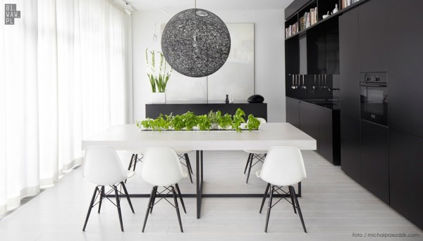 Moving to the dining area and kitchen, we can get a real sense of the modern, sleek design style with lots of black and white features.