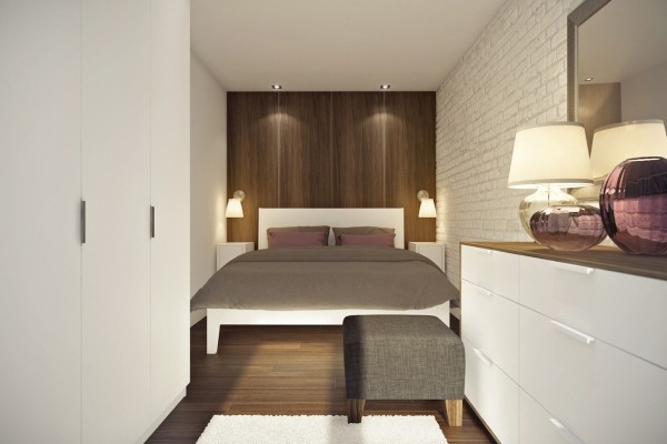 Using wood for the accent wall behind the bed gives the illusion of a headboard.