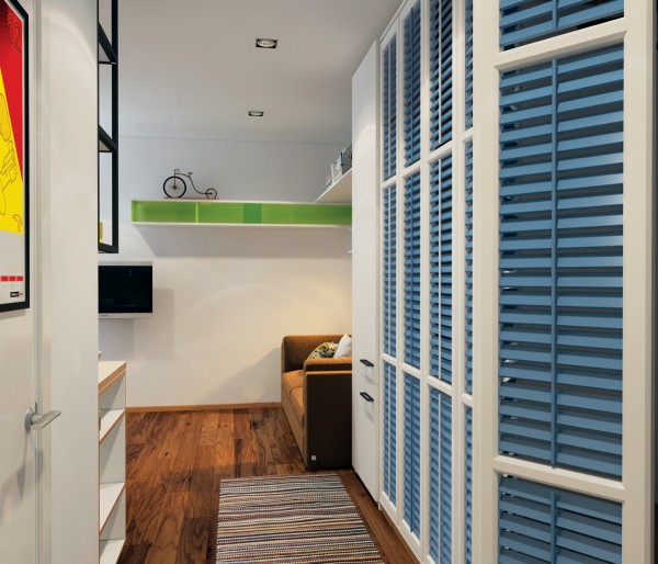 Storage is a necessity, no matter how much room you have. By using these adorable blue shutters to disguise shelving, the designer brings color into the space and helps the room to feel bigger.