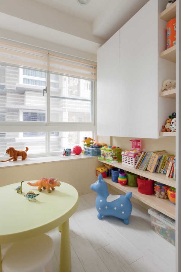 Brightly colored kids toys and books are easy to tuck away in sophisticated cabinetry.