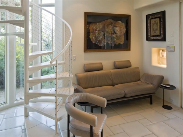 A spiral staircase hints at the overall modern style of the home.