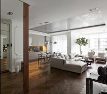 The first apartment comes from architect Sergey Makhno and uses many neutral colors to create a simple but luxurious atmosphere throughout the house. The herringbone hardwood floors serve as a foundation for a largely white and wood interior.