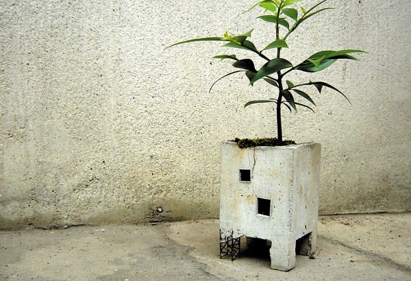 For a more industrial option, consider this concrete planter that is made to look like an abandoned building.