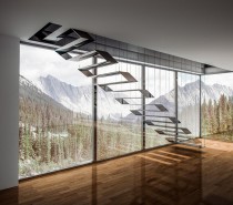 Here's another staircase with a remarkable floating effect, this time with an ultra-modern twist. The treads give the effect of a flat transparent ribbon folded over itself to form a passage to the second story. The suspension wires are ultra-thin to prevent obstruction of the landscape.