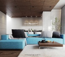 This home design in Lugano, Switzerland, offers a cheerful approach to a minimalistic and natural interior. The bright blue sofa with oversized gray pillows definitely makes a bold first impression. It's the only non-neutral piece used throughout the entire living room, yet this block of color more than invigorates the room.