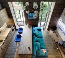 A 49-metres-squared loft in Kiev by Ivan Yunakov (http://yunakovdesign.com) also uses signature shades to create harmony in cosy spaces. High-ceilinged brick and panelled wood fixtures afford the height for long-lined doors, which are stretched horizontally by similar-shaped benches. A turquoise couch with electric blue suede single seats offer seats to look at bauble lighting, the only rounded fixture in the room.