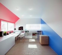 Clear, white ceilings allow bubblegum red and ocean blue to dramatically border this minimalistic office design.