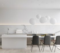 This white kitchen breaks it up, with white marble streaking grey against a minimal backdrop. Taupe cabinetry and wood-and-charcoal chairs help mix the palette, while white decorations float to the ceiling.