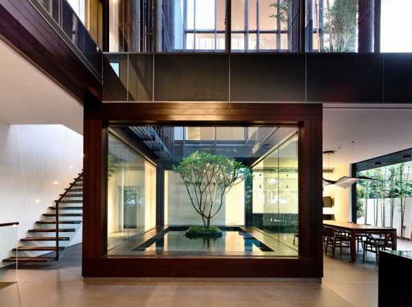 One of the most notable features in this modern home is the interior courtyard. We have featured homes with stunning courtyard elements before, but this one is no less impressive. It's two story height allows it to be enjoyed from almost any space in the home. The architect points out that in addition to the natural light infusion, it 
