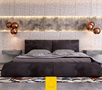 Gorgeous! This bedroom makes an immediate visual impact with rough textured concrete in a sharp geometric pattern, with oversized headboard panels above and below. Copper lamps from Tom Dixon hover above the cantilever bedside tables (also concrete) and a bright patterned rug energizes the color palette.