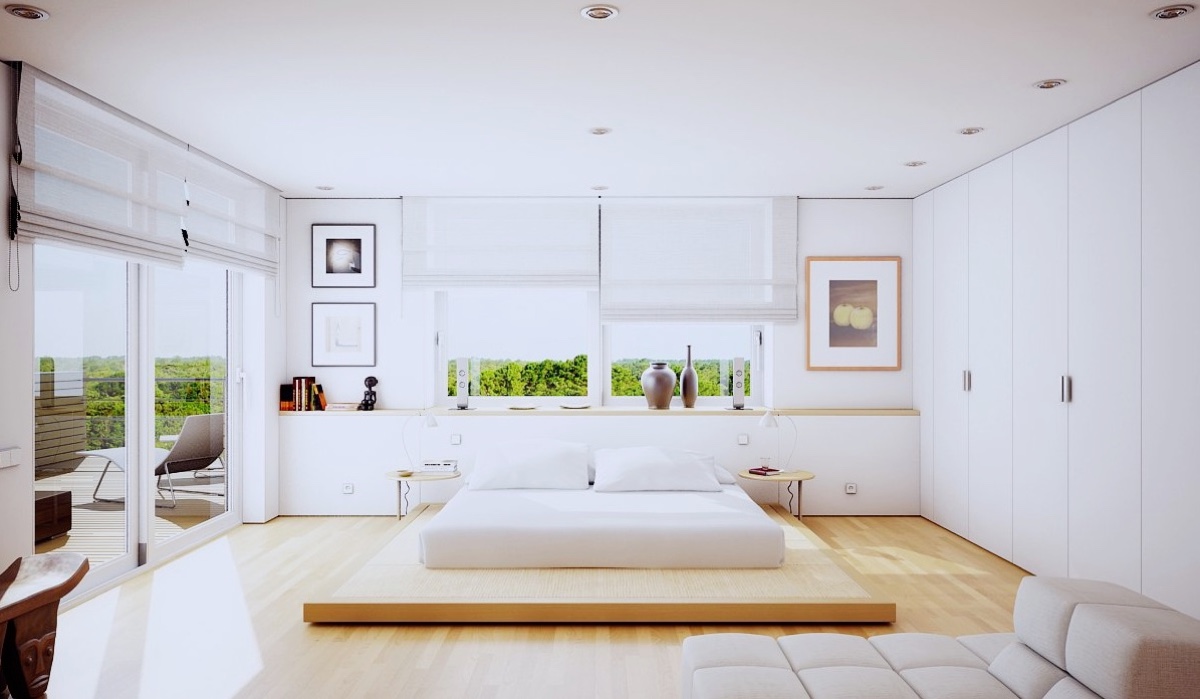 A Japanese-style bedroom is a well-known way to imitate simplicity. A futon-style bed and chaise longue take centre stage in this white-walled and wooden-floored space.