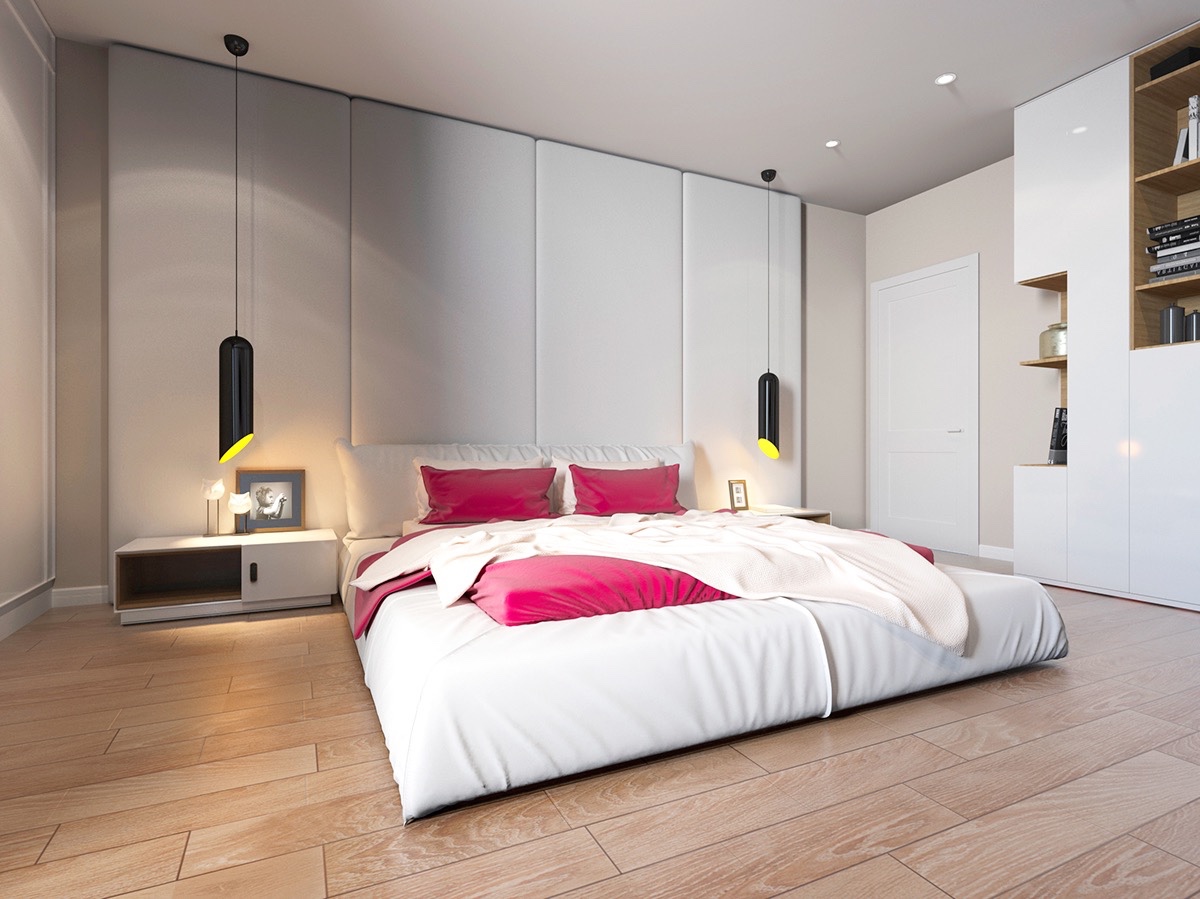 Bright colours can also make features pop in a room, amidst simpler background tones. White walls and light wooden floors in this bedroom hero distinctive cylindrical hanging lights and shocking pink bedding.