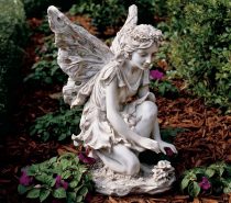 Toscano Fiona, the Flower Fairy Sculpture: Toscano Fiona has an almost magical presence, as she reaches down to tend the flowers she governs. Nestle her amongst a low-lying floral setting so her white wings can pop over flower heads.